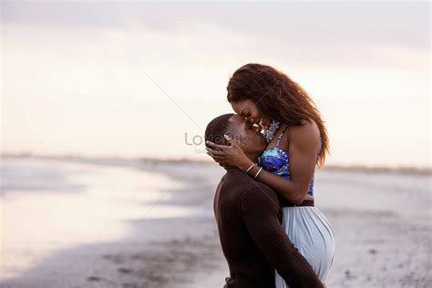 couple hugging on the beach|couples hugging on beach.